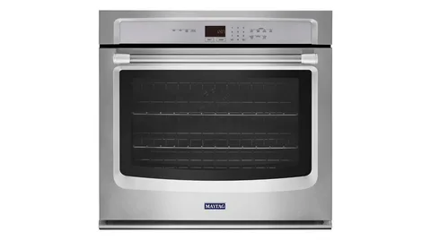 Built-in Maytag stainless steel wall oven fitted inside custom kitchen cabinetry